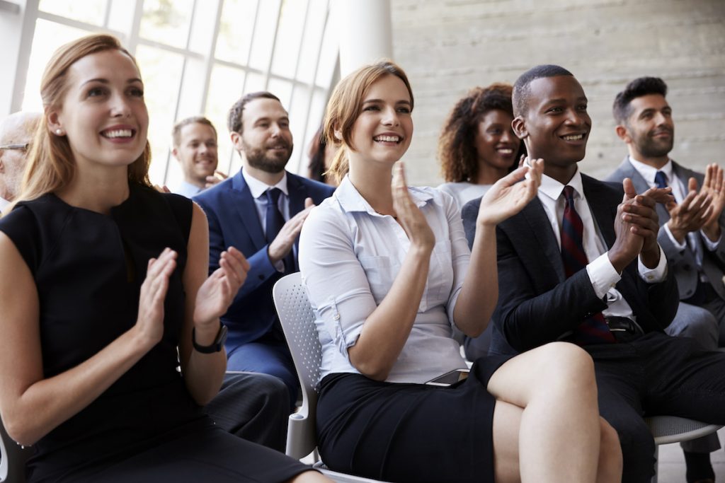 Audience Applauding Speaker At Business Conference